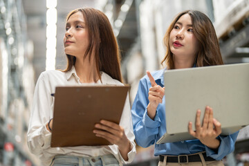Female engineers team discussing inventory in warehouse logistics and supply chain planning,...