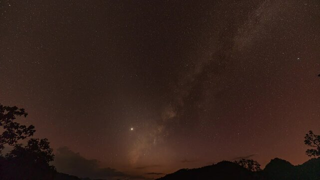 time lapse day to night The Milky Way stands perpendicular to the summit of Mount. stunning colorful pink sky above the mountains at dusk The pink sky at dusk, the Milky Way begins to shine.