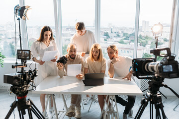 Team script. Media brainstorm. People working creative project in studio. Video shooting art collaboration model photographer director.