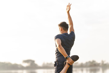 Obraz premium A male athlete enjoys a morning run in the park, smiling and exercising outdoors. Embracing fitness and happiness, he maintains a healthy lifestyle, feeling energized and positive in nature.