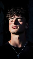 Fototapeta premium Serene Young Man Relaxing Sunlit Portrait Closeup Peaceful Calm Men s Fashion