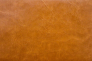 Brown or orange textured leather background. Abstract leather texture.