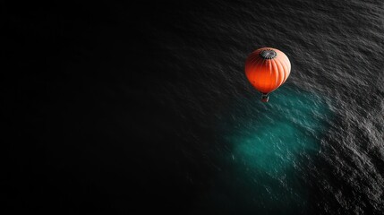 Hot air balloon flying over a dark sea with a light patch, travel, tourism, adventure