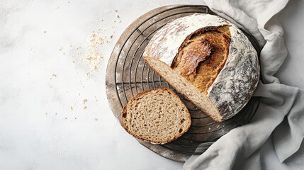 Rustic sourdough loaf sliced, cooling rack, kitchen, flour