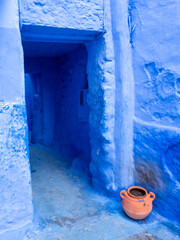 Chefchaouen,  the blue city in Morocco - blue doorway with contrasting terra cotta pot