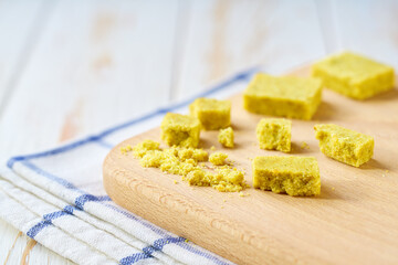 bouillon cube on a cutting board, with copy space for text.