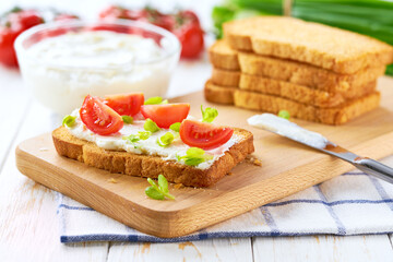 Fresh made cream cheese toast bread with herbs, cherry tomatoes, simple and delicious snack.