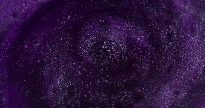 Purple vortex. Spiral paint. Defocused thick dark lilac stream liquid potion mixed with shiny sparkles. Violet caramel boils with bubbles texture.