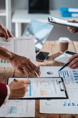 A close-up of a businessman explaining finance, business planning, and marketing during a meeting at the table,demonstrating teamwork and collaboration to achieve strategic goals successful outcomes