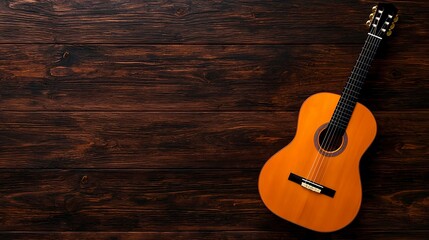 Obraz premium Acoustic guitar resting on wooden surface in natural light