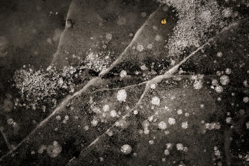 abstract cracked sheet of frozen ice nature fascinating white black gray landscape with texture detail winter extreme temperatures holiday christmas transportation backdrop