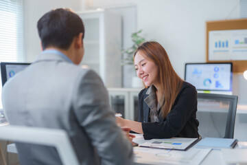 Asian businesspeople discussing and working together in office meeting