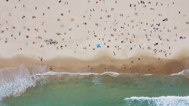 Aerial top view of Bondi beach crowded with people in summer, Sydney, New South Wales, Australia