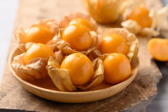Cape gooseberry or Golden berry (Physalis peruviana) in wooden bowl, Healthy fruit