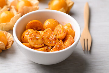 Fototapeta premium Cape gooseberry or Golden berry (Physalis peruviana) with chili powder and sugar, Spicy fruit salad