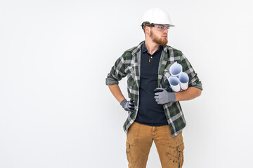 Male builder. Engineer in overalls and helmet holds blueprints and projects in his hands.