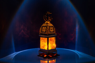 Lantern with moon symbol on top on dark  blue background for the Muslim feast of the holy month of Ramadan Kareem.