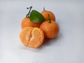 Ripe mandarin with leaf.Tangerine with leaf and peeled pieces isolated on white background