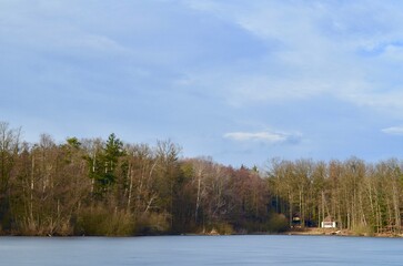 lake landscape, autumn frozen pond, blue sky background