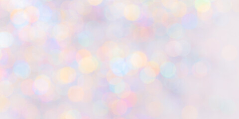 Fototapeta premium Defocused abstract bokeh background pastel colored, flare from lights, color gradient, blurred circle bokeh as holiday texture. Glittering aesthetic textured lighting pattern