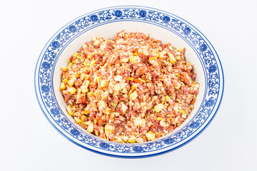 A bowl of corn, cabbage and pork filling
