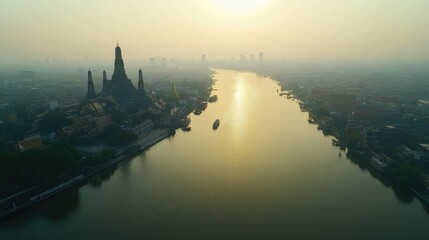 Fototapeta premium A stunning aerial view of the Chao Phraya River in Bangkok, with the Grand Palace, Wat Arun Temple, and the city's bustling skyline, reflecting the cultural and business hub of Thailand