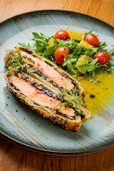 salmon pie with arugula salad on table