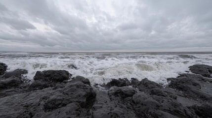 Obraz premium Stormy ocean waves crashing on rocky shore. Use weather report