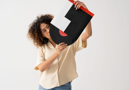 Mockup Of Woman Removing Record From Customizable Sleeve