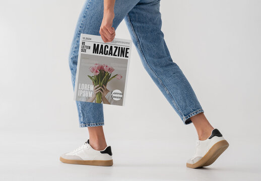 Mockup Of Woman Holding Customizable Magazine, Walking
