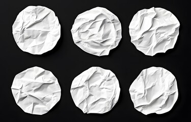 Fototapeta premium Six crumpled white paper circles on black background. (3)
