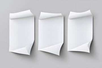 Three blank white papers with curled edges on gray background.