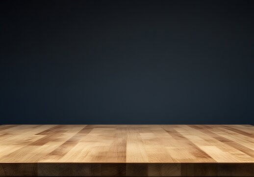 Empty light wooden table against dark blue background.