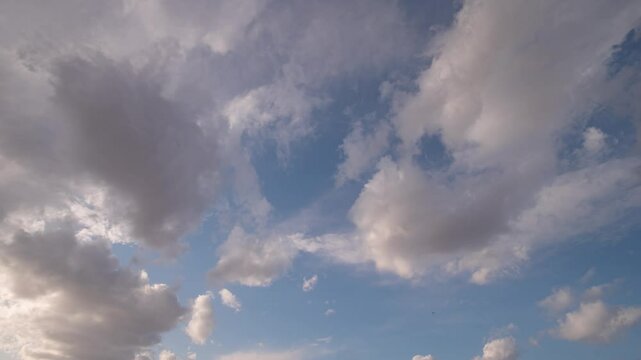 Timelapse of clouds moving across the sky by day.