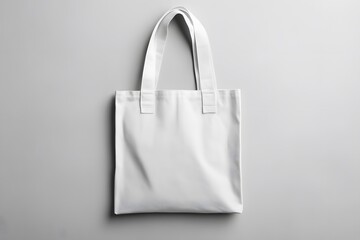 Blank white tote bag mockup on gray background.