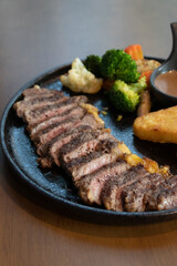 Delicious steak with hash brown, vegetables and sauce.
