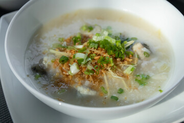 Rice congee with soft-boiled egg flavor with pickled chili vinegar and ground dried chilies