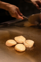 Deliciously seared scallops on hot pan.