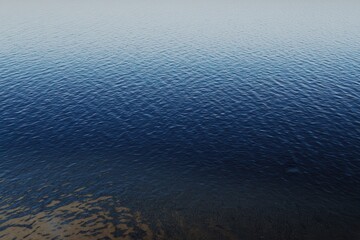 Obraz premium Mountain Lake Gradient: A mountain lake with water transitioning from clear near the shore to deep blue in the center.