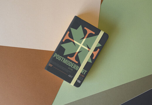 notebook with an elastic closure rests on a pastel geometric background. REady for mockup