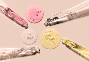 samples serum tests glass pipettes with drops of serum on a light beige background