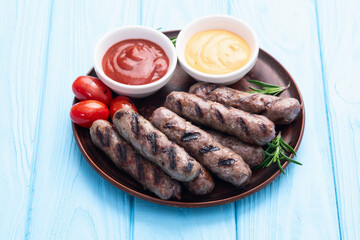 Grilled beef sausages with rosemary sauce and tomatoes photography . Top view