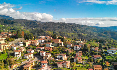 Naklejka premium Aerial view of Barga, Garfagnana, showcasing the picturesque Italian village on a sunny day