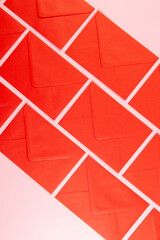 Top view of red envelopes on pink background. Post flat lay. Copy space.