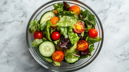 A bowl of fresh mixed greens with cherry tomatoes, cucumber, and a light vinaigrette