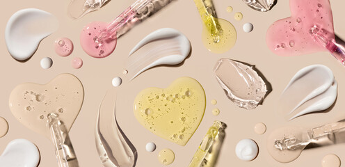 samples of cosmetic care products smear of cream texture on a beige background