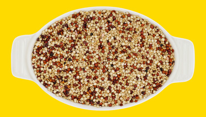 White bowl filled with a colorful mix of quinoa grains, isolated on a vibrant yellow background, perfect for healthy food, superfoods, or cooking concepts.