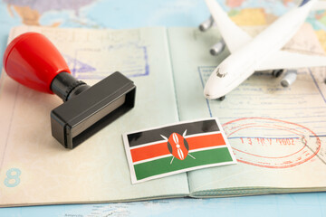 Kenya flag with passport and airplane for travel.