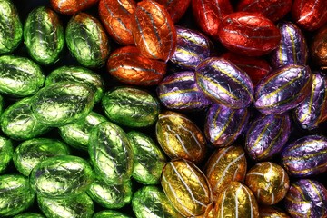 Chocolate Easter eggs in foil sorted by color, a treat for the Easter holidays.