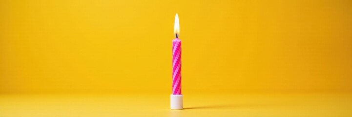 pink striped birthday candle in flames on a bright yellow surface, spark, flame
